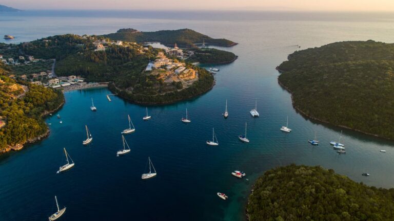 Sailing yachts anchored in Syvota bay, Greece, at golden hour