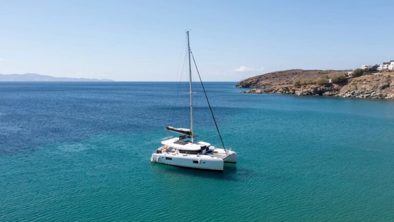 Sailing catamaran anchored in a turquoise bay in the Greek islands