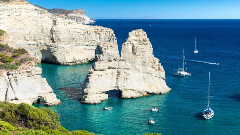 Sailing yachts anchored by the white rock formations of Kleftiko, Milos
