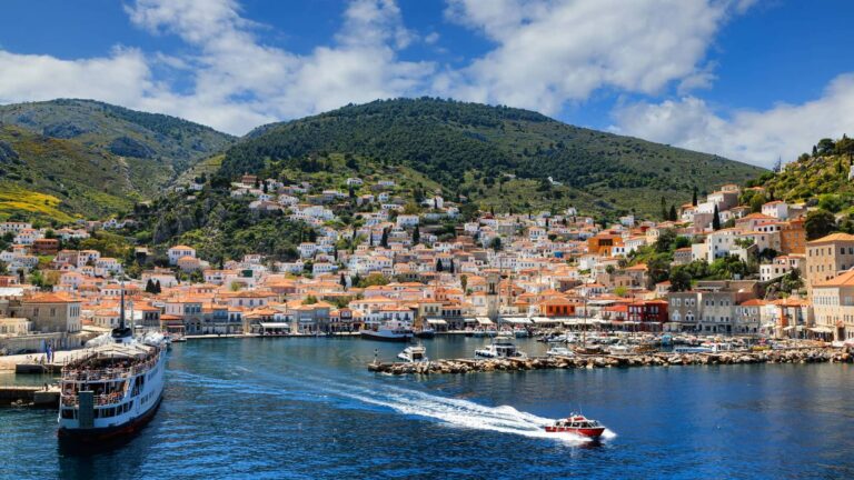 Boats in Hydra harbour below the hillside town, Saronic Gulf, Greece